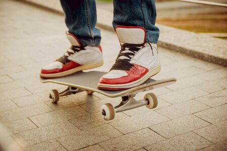 Young man riding a skateboard. Town Squareの写真素材