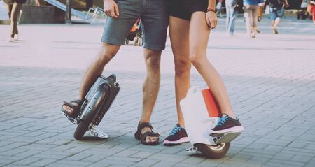Young couple driving on monowheel in the parkの写真素材