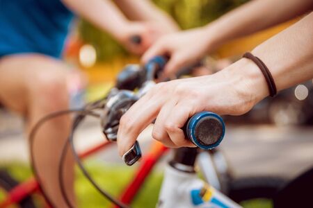 Cycling young couple. In the park. Beautiful bicycle lane.の写真素材