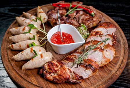 Sliced meat with sauce on a plate.の写真素材