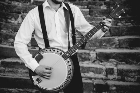 View of musician playing banjo at the street. Authentic backgroundの写真素材