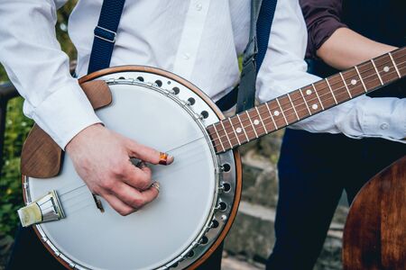 View of musician playing banjo at the street. Authentic backgroundの写真素材