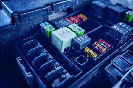 Replacing fuses in the fuse box of the car. Car repair. Service stationの写真素材