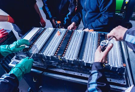 Charging the batteries of the elecric motor. Disassembling the battery of an electric vehicle engine. Car serviceの写真素材