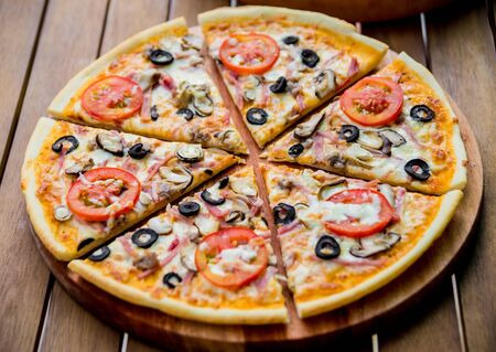Large pizza on a wooden table. Restaurantの写真素材