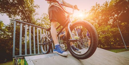 Boy stands with his bmx in a park.の写真素材
