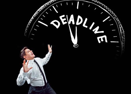 Businessman on a background of black wall.の写真素材