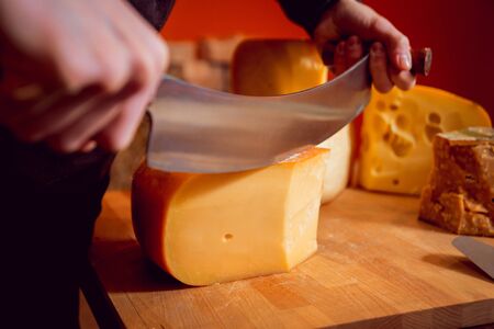 Cut with a knife piece of cheeseの写真素材