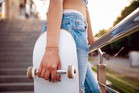 Young girl with skateboard. In the parkの写真素材