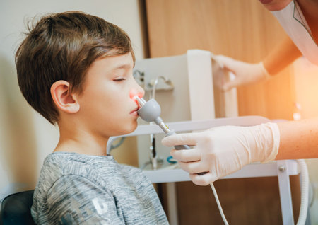Treatment and warming-up the nose of a young boy. Modern Pediatrics.の写真素材