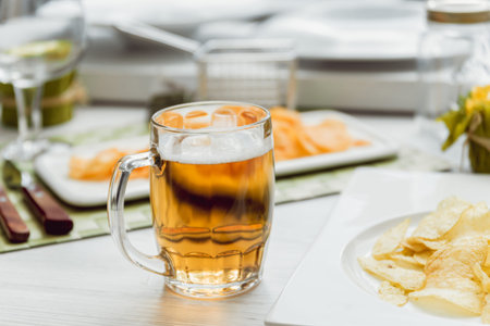 Beer and chips on the large white table. Restaurantの写真素材