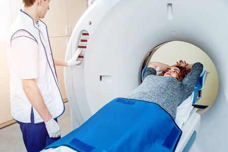 Medical equipment. Doctor and patient in the room of computed tomography at hospital.の写真素材