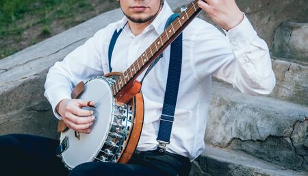 View of musician playing banjo at the street. Authentic backgroundの写真素材
