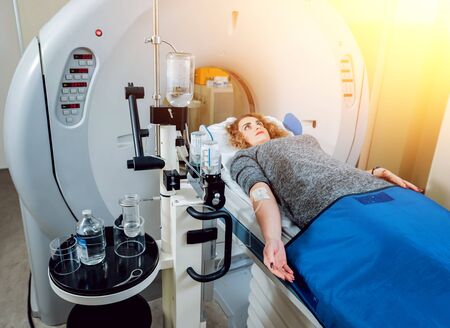Medical equipment. Doctor and patient in the room of computed tomographyの写真素材