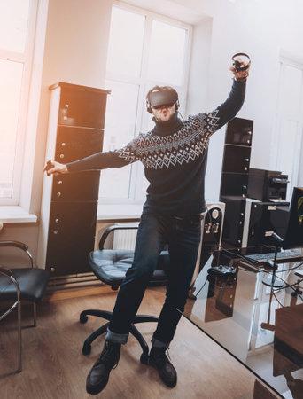The young man plays a game at the office.