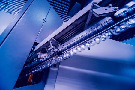 Beverage factory interior. Conveyor with bottles for juice or water. Modern equipmentsの写真素材