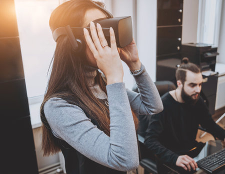 The young man with girlfriend plays a game at the office.