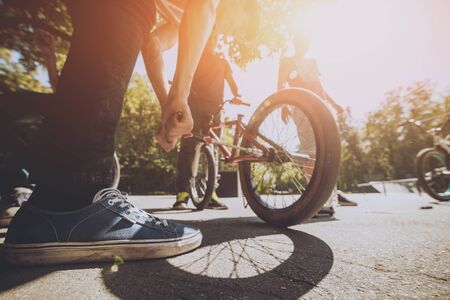 Bmx bicycles lays on the ground in the skatepark. Bicycle repairの写真素材