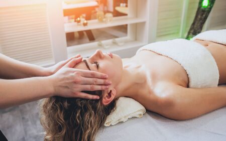 Beautiful woman in spa salon getting facial massage. Relaxingの写真素材