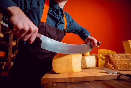 Cut with a knife piece of cheeseの写真素材