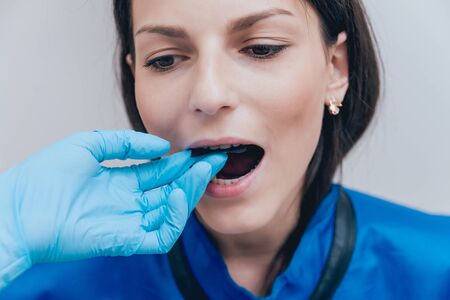 Dentist make x-ray image for young woman in dental clinic.の写真素材