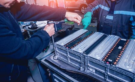 Charging the batteries of the elecric motor. Disassembling the battery of an electric vehicle engine. Car service