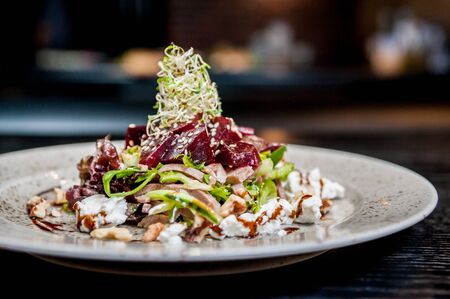 Salad with meat and cheese on a plateの写真素材