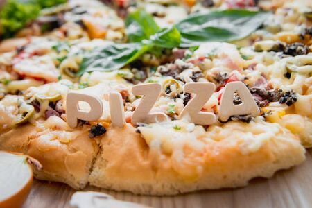 Large pizza on a wooden table. Restaurant.の写真素材