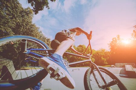 Boy riding a bmx in a park.の写真素材
