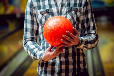 Young man at the bowling alley with the ball.の写真素材