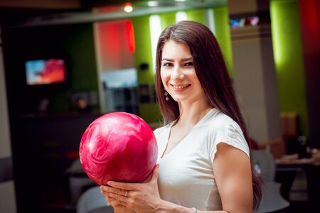 Beautiful girl at the bowling alley with the ball.の写真素材