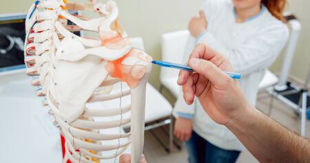 Patient with orthopedist doctor in his office.の写真素材