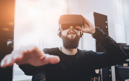 The young man wearing virtual reality goggles