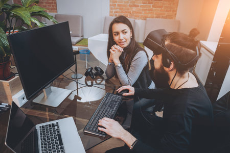 The young man with girlfriend plays a game at the office.