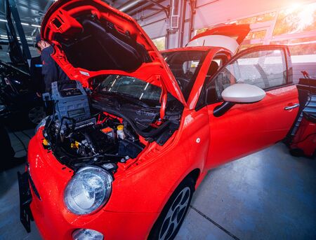 Electic car with open hood. Details of electric car engine. Battery.の写真素材