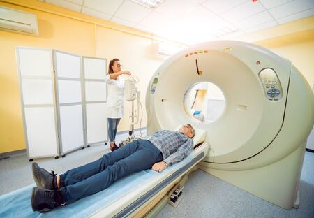 Doctor and patient in the room of computed tomography at hospital. Medical equipment.の写真素材