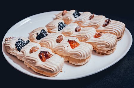 French meringue cookies on the white plate. Restaurantの写真素材