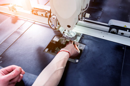 Fabric industry production line. Textile factory. Working tailoring process cloth. Modern equipmentの写真素材