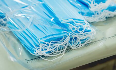 Woman sew the facial medical at sewing machine. Coronavirus pandemia. Diy protective mask against virus.の写真素材