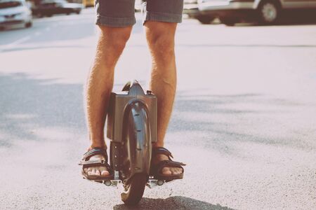 Young couple driving on monowheel in the park.の写真素材