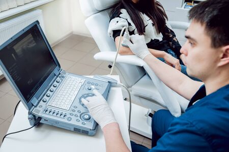 Patient with orthopedist doctor in his office.の写真素材
