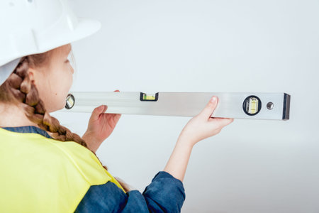 Little girl on the white background. Construction and renovation interior. 