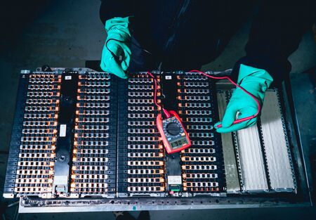 Charging the batteries of the elecric motor. Disassembling the batteryの写真素材