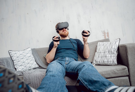 The young man playing games with virtual reality gogglesの写真素材