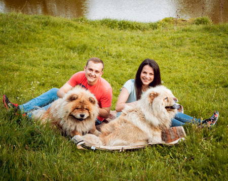 Young couple with the dogs in the park