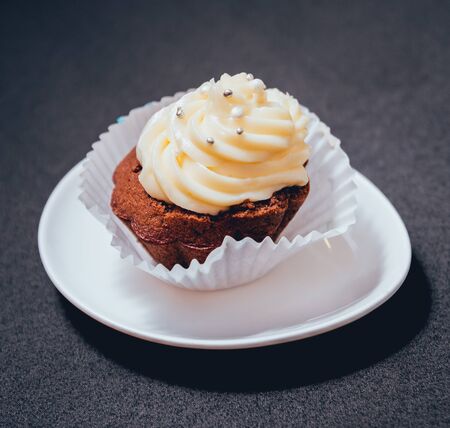 Chocolate caramel cupcake with nuts and butterscotch syrupの写真素材
