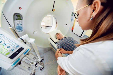Doctor and patient in the room of computed tomography at hospital. Medical equipment.の写真素材