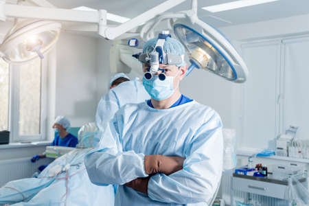 Spinal surgeon in operating room with surgery equipment. Modern medical backgroundの写真素材