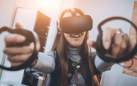The beautifull girl playing games with virtual reality goggles
