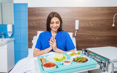 Tray with breakfast for the young female patient.の写真素材